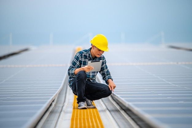 Asian engineer solar cell factory working with safety helmet outdoor _ Premium Photo